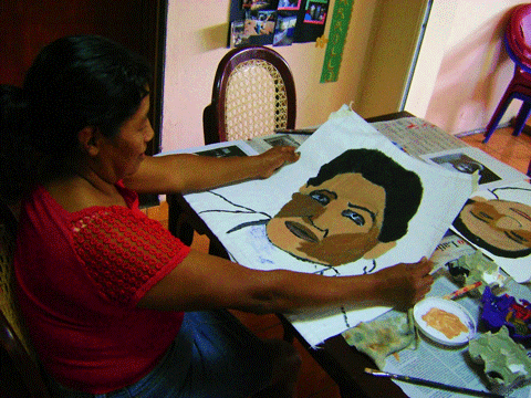 Salvadoran woman holding portrait, ArtCorps Artist Laura Smith, FUNDAHMER