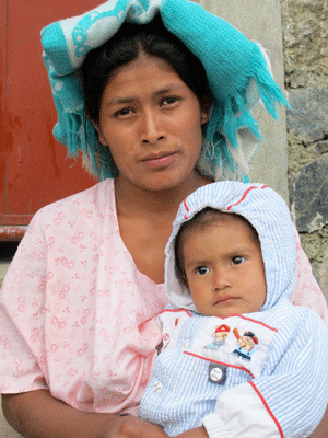 Indigenous woman holding daughter, taken by ArtCorps Artist Isabel Carrio for 100 Faces of Women of puruhla Women's day exhibit