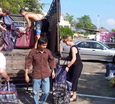 Mary Kay & Phichai loading supplies into the truck