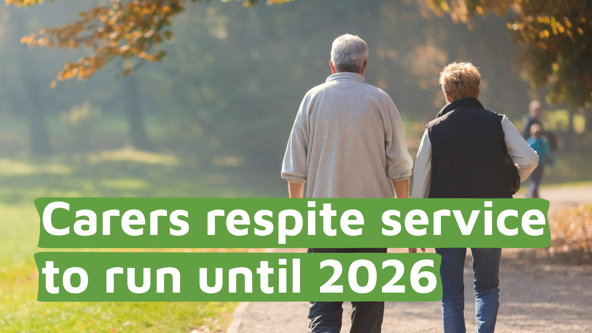 An elderly couple walking together in a park with the title 'Carers respite service to run until 2026'.