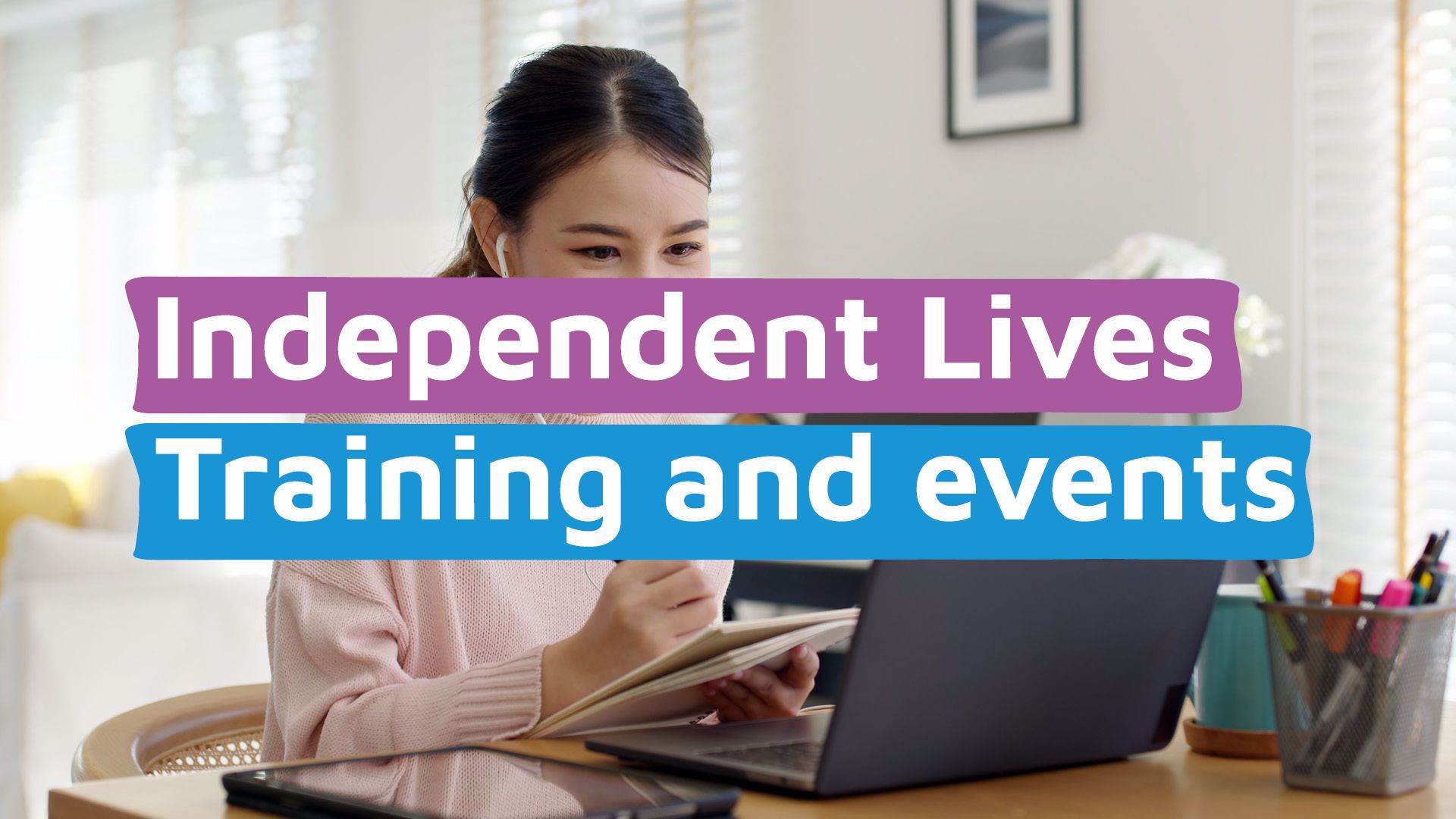 A lady reading information on a laptop, holding a pad with the words 'Independent Lives Training and events'