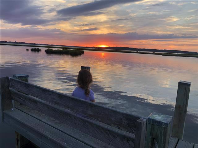 My granddaughter watching the sunset across Little Assawoman Bay, Delaware.