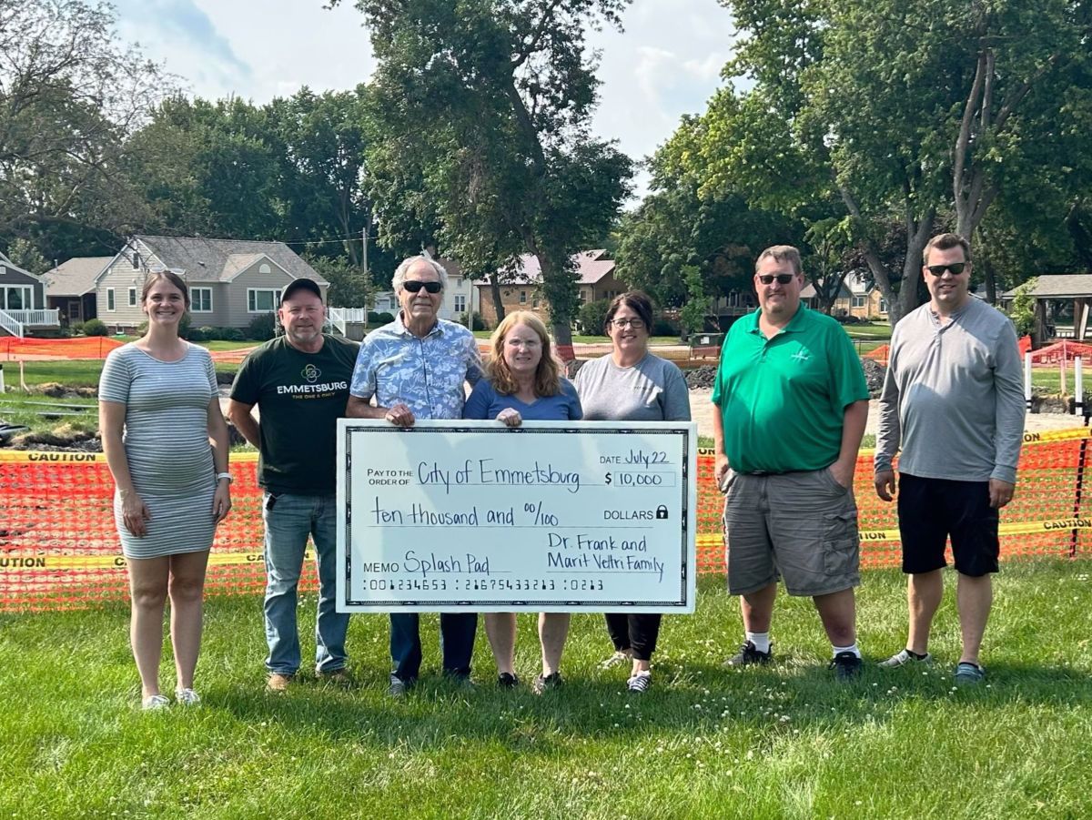 Photo of Frank and Marit Veltri presenting check for splash pad to City representatives