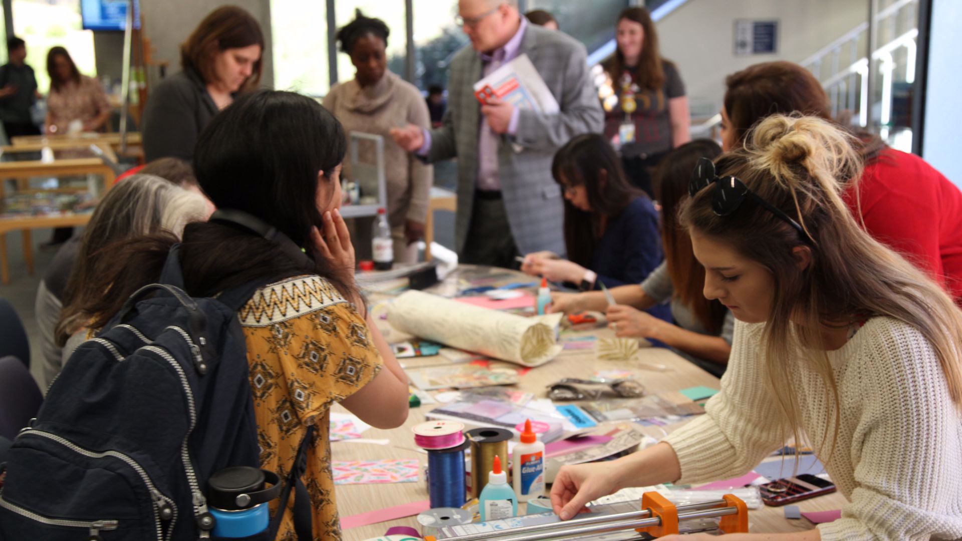 A picture of people decorating bookmarks.