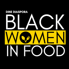 Logo from Dine Diaspora with black background and white and yellow letters stating "Black Women in Food"; the 'O' in women is a plate with a spoon and fork graphic in it