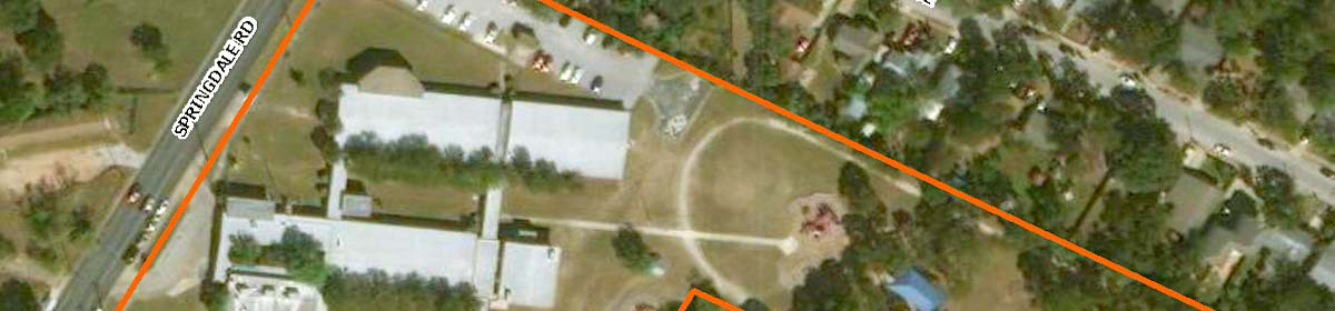Aerial photo of Sims Elementary with a red line showing its boundary along Springdale Road. 