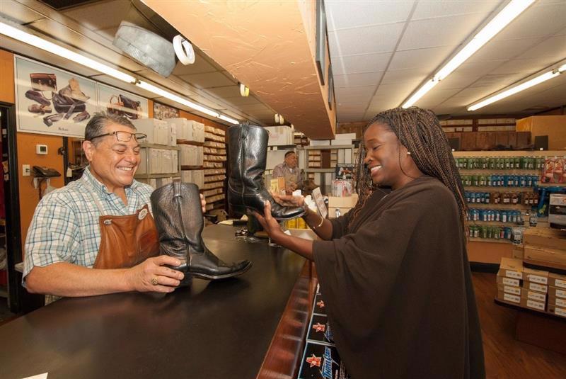 Photograph of a mural titled “The Sisterhood of Two Hearts” displayed on the exterior wall of Mexic-Arte Museum. The artwork features vibrant, colorful depictions of cultural unity between Austin, Texas, and Saltillo, Mexico. Artists: Ana Sofia and Chous. Photo by Lori Renteria. Text overlay says “The Creative Reset” with a City of Austin seal.