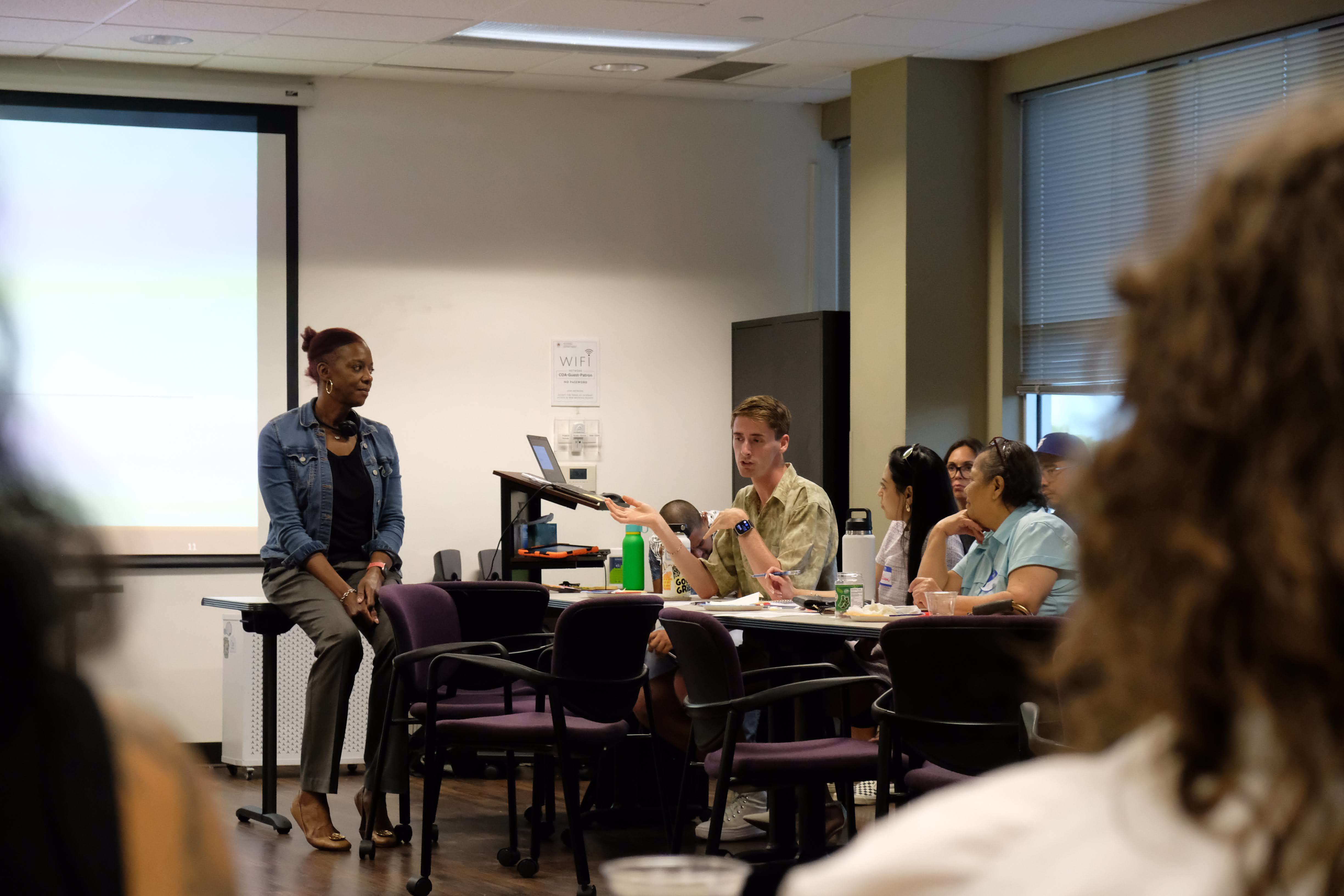 Photograph of a mural titled “The Sisterhood of Two Hearts” displayed on the exterior wall of Mexic-Arte Museum. The artwork features vibrant, colorful depictions of cultural unity between Austin, Texas, and Saltillo, Mexico. Artists: Ana Sofia and Chous. Photo by Lori Renteria. Text overlay says “The Creative Reset” with a City of Austin seal.
