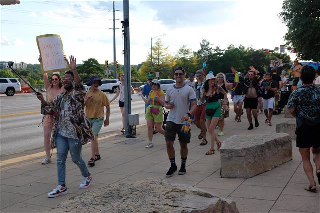 Photograph of a mural titled “The Sisterhood of Two Hearts” displayed on the exterior wall of Mexic-Arte Museum. The artwork features vibrant, colorful depictions of cultural unity between Austin, Texas, and Saltillo, Mexico. Artists: Ana Sofia and Chous. Photo by Lori Renteria. Text overlay says “The Creative Reset” with a City of Austin seal.