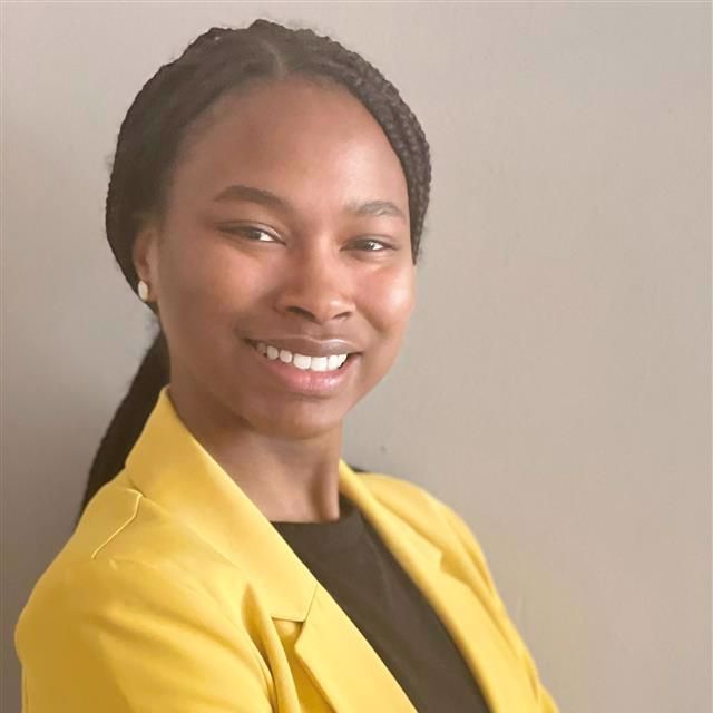 Photo of Constance in a yellow blazer