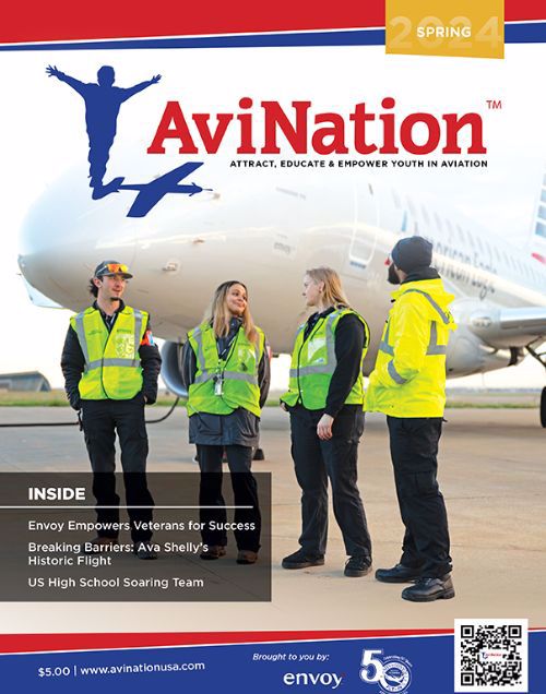 4 young people standing in front of a commercial aircraft