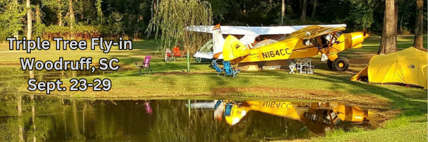 Campsite beside pond with aircraft