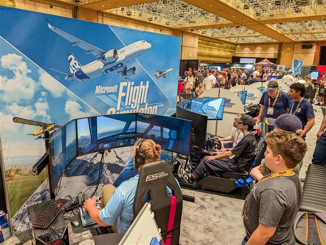 Large room of people enjoying flight simulators