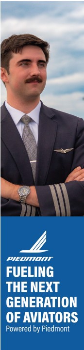 Man in pilot uniform standing with arms crossed