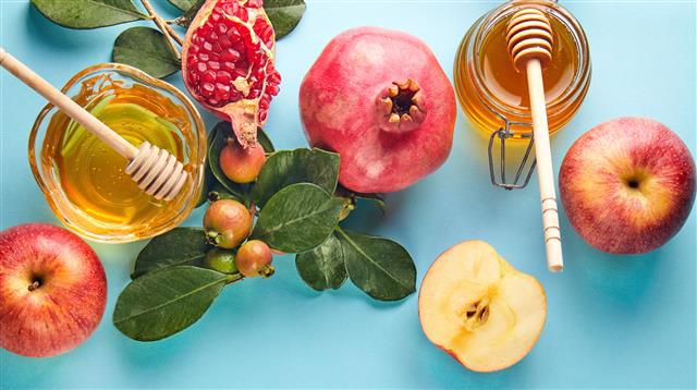 photo of apples, pomegranites, and  honey