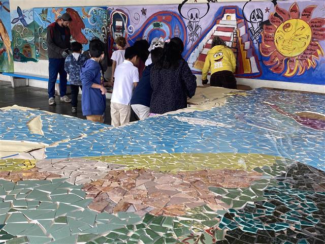 Students working on a mosaic