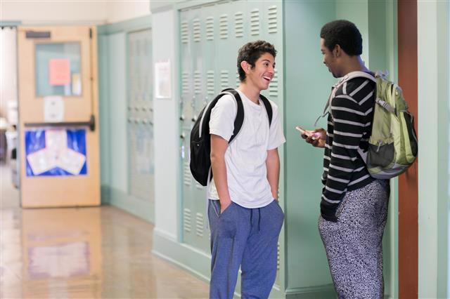 Stock photo of high school students in hallway