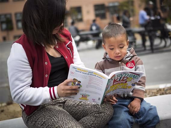 Adult reading to younger child
