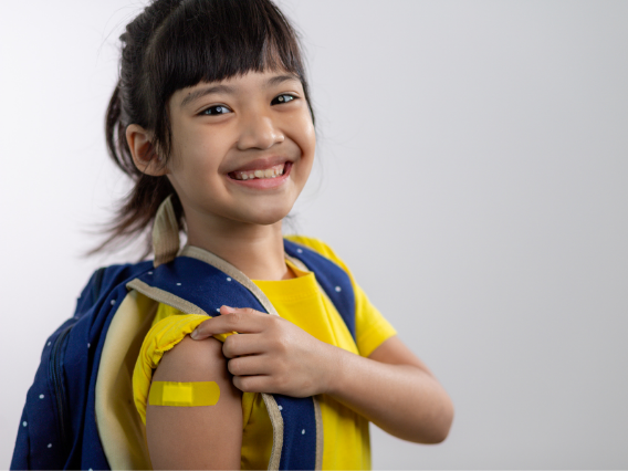 Student with backpack and yellow bandaid on upper arm