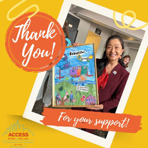 Superintendent Dr. Maria Su wearing new laser cut earnings and posing with a painting from a student at the AccessSFUSD The Arc's Art Show