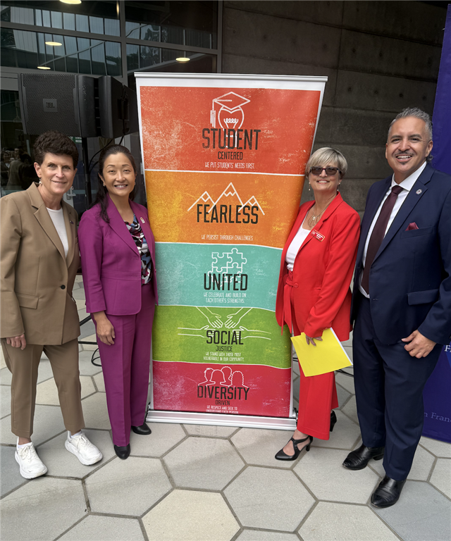 Dr. Su with CCSF and SFSU leadership in front of the core values banner
