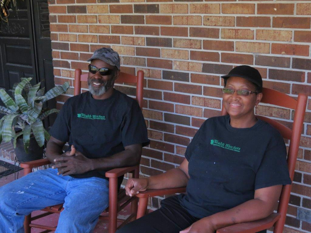 Farmers Calvin and Caria Hawkins sitting on a porch.