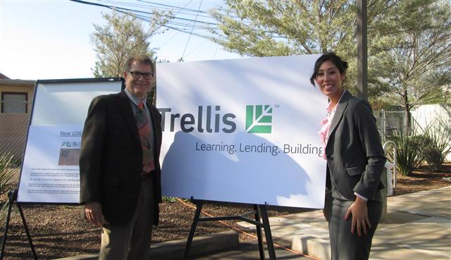 Armida Lopez stands in front of a Trellis sign