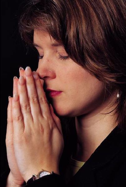woman praying with eyes closed