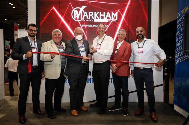 Markham Mayor with York Region Chairman and Syntronic representatives cutting red ribbon