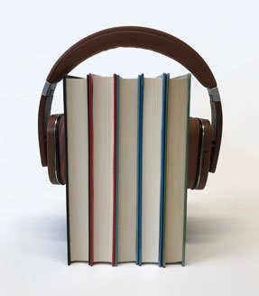 Photo shows five standing books with a set of headphones holding them together. Source: pxfuel.com