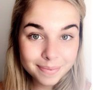 Photo of Tegan Lecheler, a young white woman with long, sandy blonde hair and green eyes smiling into the camera