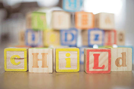 photo of blocks spelling out the word "child"